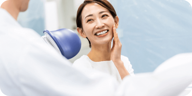 A smiling woman at the dentist / orthodontist.