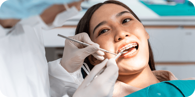 A lady at the dentist with braces on