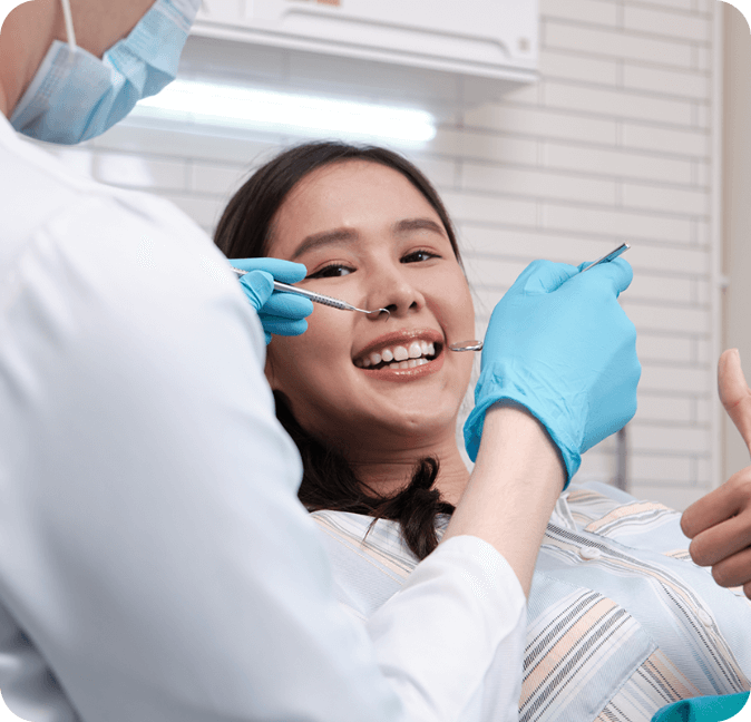 A patient in a dentist's office smiling before getting a dental implant.