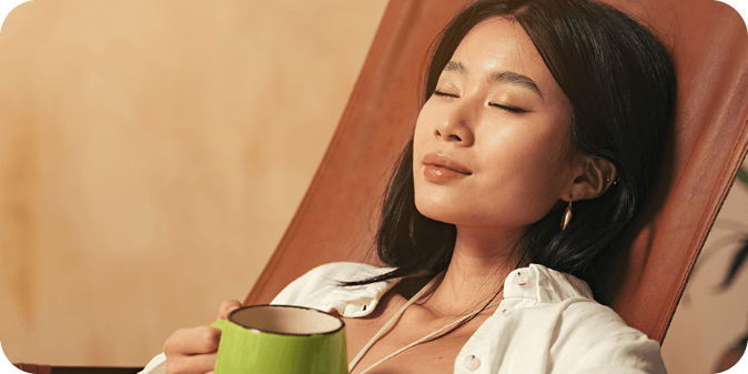 A woman relaxing with a drink in hand